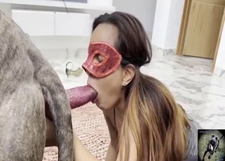 Red mask brunette performs fellatio on a dog