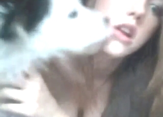 Super-pretty girl fucks dog on all fours for webcam